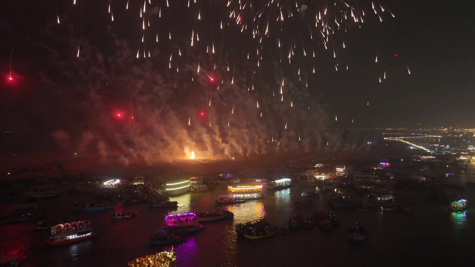 Fireworks over boats lit along the Ganga at Dev Diwali
